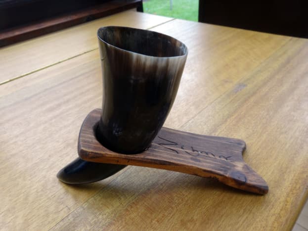 Viking drinking horn in its stand and ready for use.