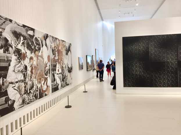 "Black Star Press (rotated 90 degrees clockwise); Press, Black Star", 2006 by Kelley Walker and "Come Out #13", 2015 by Glenn Ligon.