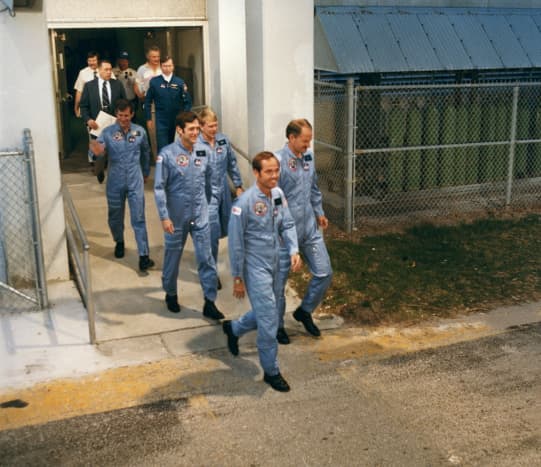 Traditional exit from the crew quarters to the &quot;AstroVan&quot; for the 11-mile trip to the launch pad.