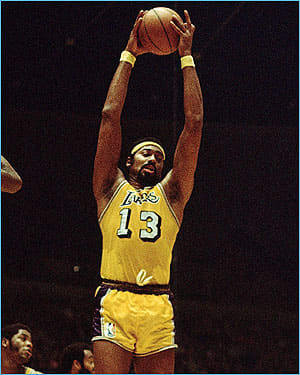 Wilt pulls down one of his 22.9 rebounds per game!