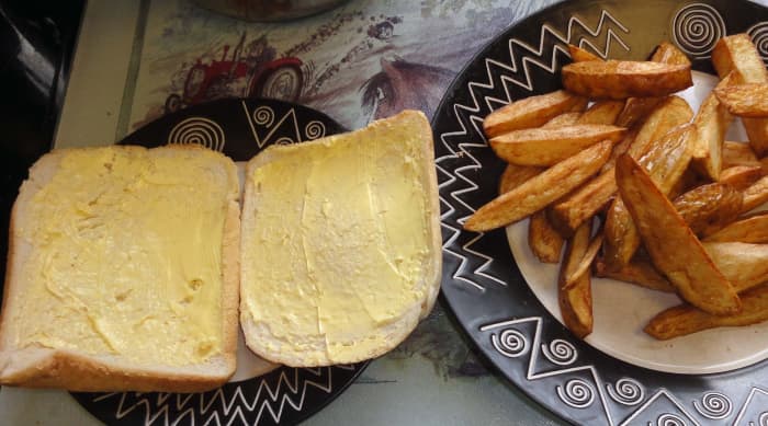 Cook chips and butter two slices of bread, crusts, bap or bread roll.