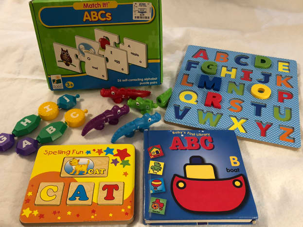 Alphabet puzzles, books, popbeads, alligators, and word activities 
