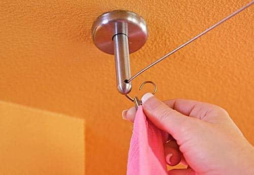 Use the hook clips for the wire cables to hang them to clip on the curtain.