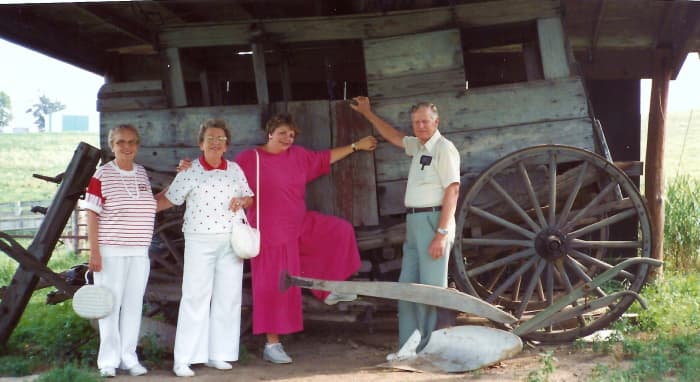 My aunt, mother, me, and my uncle are standing in front of an old stagecoach on the grounds of the Cody Homestead.