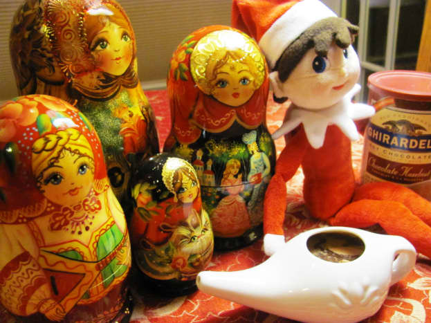 The elf served hot cocoa to his Russian doll friends out of a neti pot.  A neti pot is a device irrigation or nasal douche device.  Nice touch, Shelf Elf!