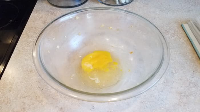 Add an egg to your mixing bowl.
