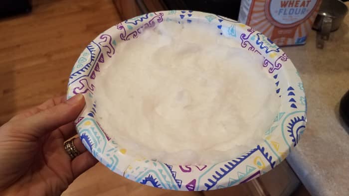Start with your crust first so it can cook while you're making the filling. The trick to this recipe is making your coconut oil ice cold. I smear mine on a plate into a thin even layer and pop it into the freezer.