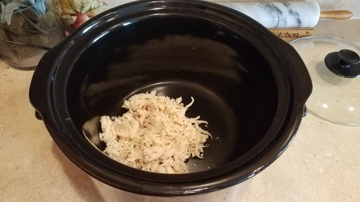 I tossed my pre-cooked shredded chicken into the crock-pot. (I like to cook my chicken ahead of time in bulk in the crock-pot. Then I can shred it all, bag it up in single breast servings, and keep it in the freezer for when I need a quick meal.)