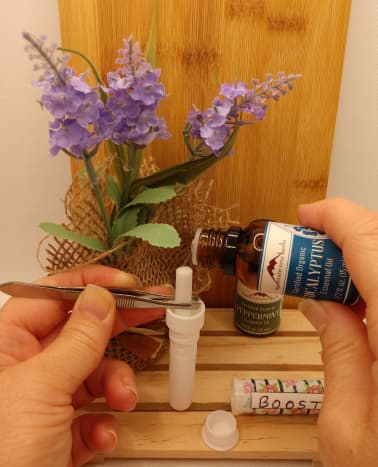 Adding essential oil drops to the inhaler wick.