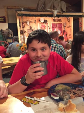 Our son Ben enjoys a lemonade at the Circle B Chuckwagon dinner.