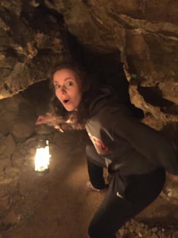 Our daughter Alissa bravely lights the way through Jewel Cave. 