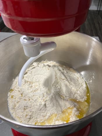 In a stand mixer with a hook attachment, combine the flour, sugar, yeast, water, milk and melted butter. Beat on a lower speed to blend.
