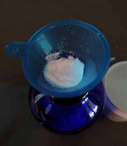 Hyaluronate powder in a funnel.