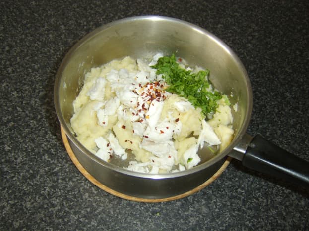 Additional fish cake ingredients are added to the mashed potato