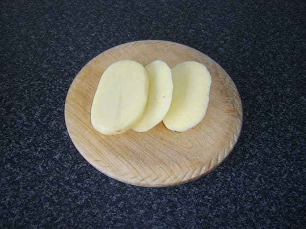 Potatoes are firstly peeled and sliced for chips