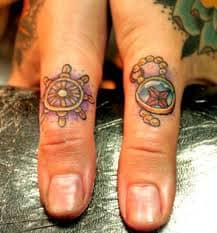 Very ornate thumb tattoos. Wonder how these will stand the test of time.