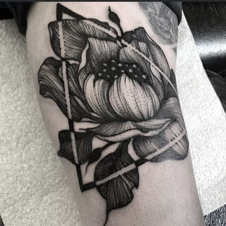 Pencil sketch art-inspired rose tattoo.