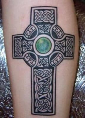 A black cross with a green gem. (by Brian Chadwick, Castle of Color, Nicholasville, KY)