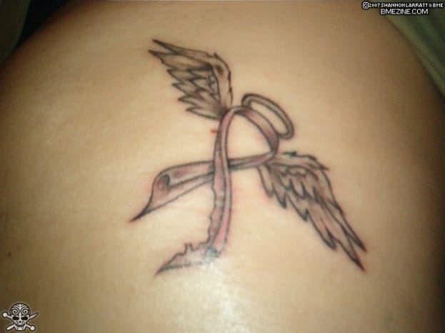 Pink ribbon tattoo stylized as angel wings and halo.