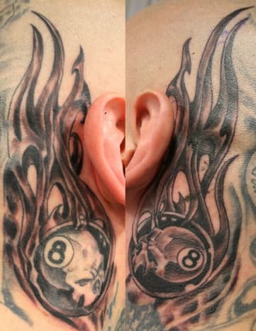 Eight ball tattoos behind the ears.