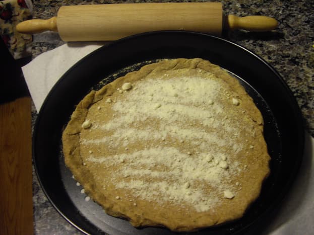 Sprinkle dough or bread with Parmesan cheese (if desired)