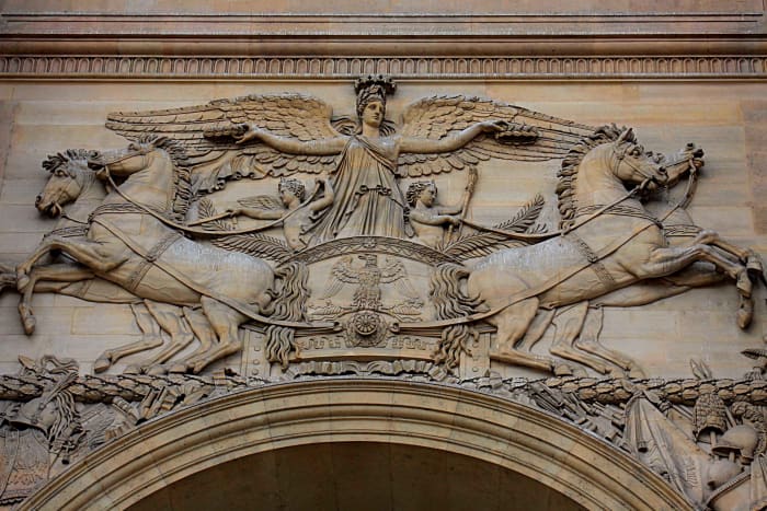 Detailed carvings over the entrance gate to The Louvre in Paris