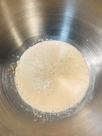 Make the yeast mixture: In a mixing bowl, combine warm water, active dry yeast, and sugar or honey. 