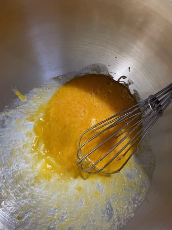 In a large mixing bowl, add the egg, egg yolks, vanilla, sugar, and honey. Whisk to combine.