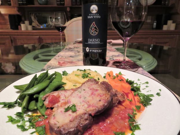 Braciole meal accompanied by a good bottle of Chianti wine.