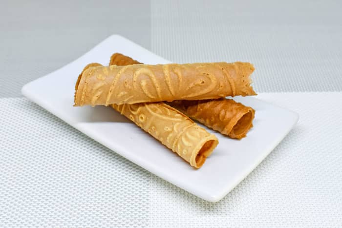 The weirdly-named Love Letters are made by quick-heating flavored batter on an iron mold then rolling the batter into cylindrical shapes. They are popular for their light taste and crispy texture.
