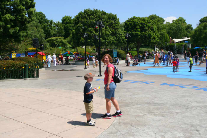 The author and her son walk by the splash pad in Duplo Village.