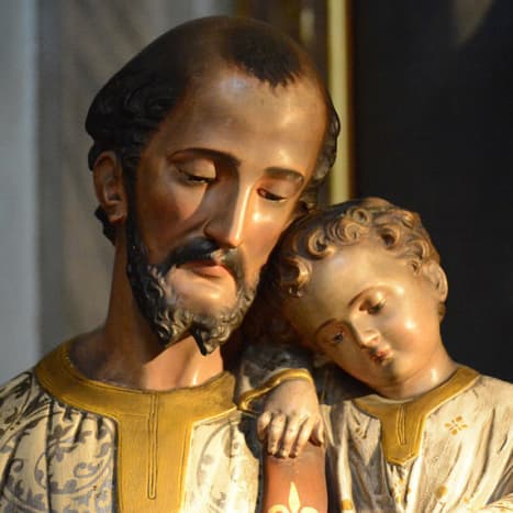 This woodcarving shows the tender union between St. Joseph and the Child.