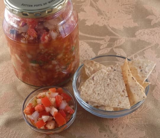 Hot and Spicy Salsa With Cilantro and Coriander, served with corn tortilla chips.