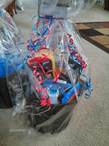 Fathers day gift bucket an ultimate dude gift ! Furnished completely at the dollar tree! This bucket includes a shammy car wash solution a spray bottle a window shield cover a washing glove air freshener