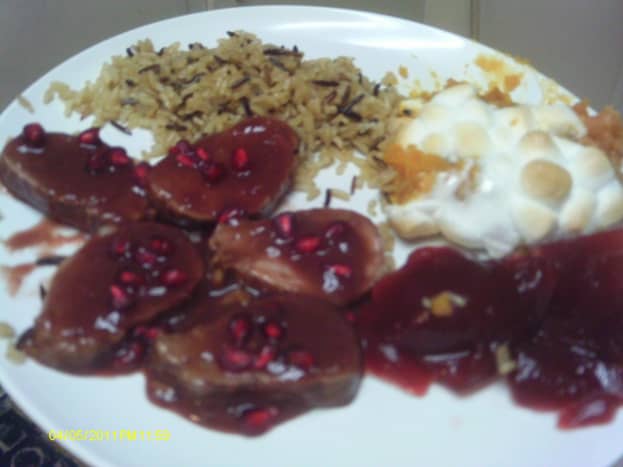 A plateful of goodness:  Pork with pomegranate, cranberry sauce, sweet potato and rice.