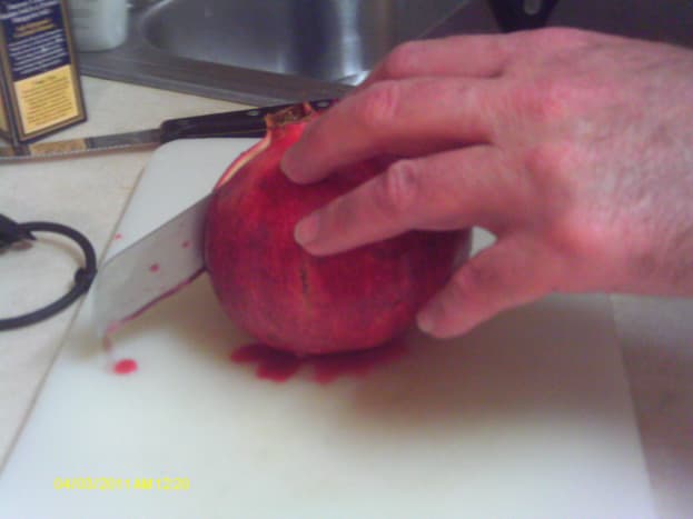 Slice the pomegranate in half to obtain the seeds. 