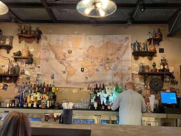 The map behind the bar really has an early 1940s feel to it. If you look closely you can see the flight paths the plane took. I love the look of all the bottles.