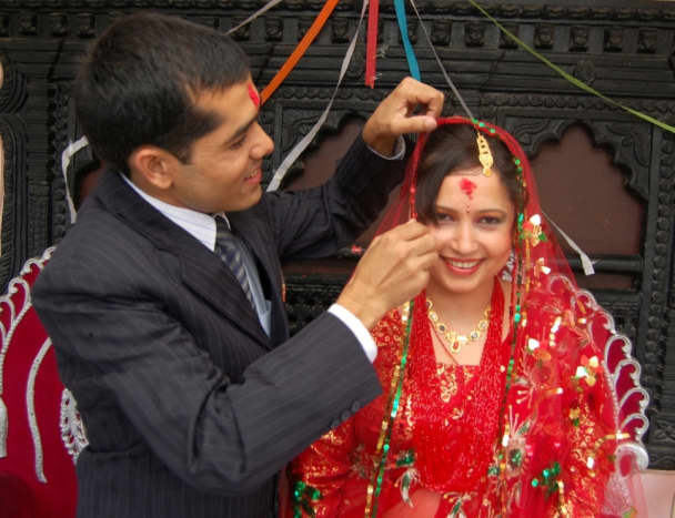 Just married: The groom tries to arrange his bride&rsquo;s headscarf