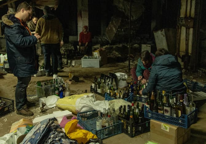 On February 26, 2022, civilians in Kyiv prepare Molotov cocktails.