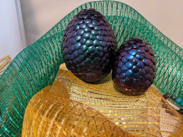 The angle you're looking at these changes dramatically based on the angle. The large egg is a green/purple mix, the smaller is blue/purple