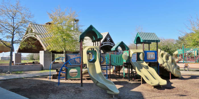 A portion of the children&rsquo;s playground with the pavilion in the background in McClendon Park