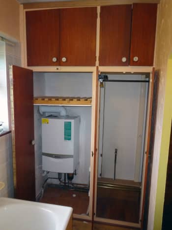 Left hand side; original airing cupboard housing the combi-boiler for the central heating; and on the right, the wardrobe emptied and ready to dismantle to make the alterations.