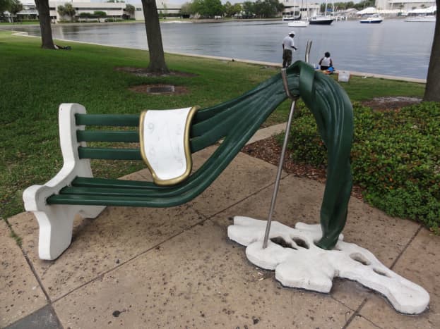 Outdoor work at the St. Petersburg FL Dali Museum. The clock melting on a bench.