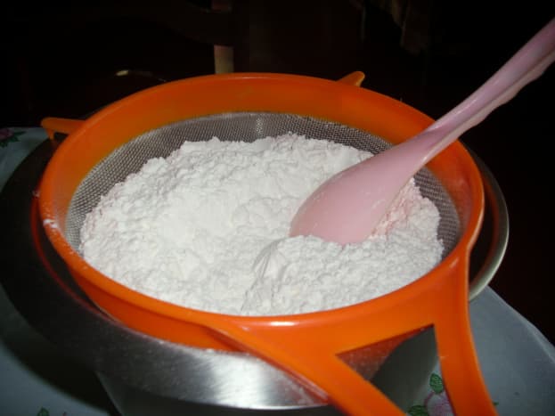 Sieving  flour and baking powder.