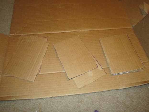 This project could be done with cork board. Since I didn't have any, but DID have an abundance of cardboard I decided to use cardboard.  I started by cutting pieces that would fit inside each box.  I cut two pieces per box.