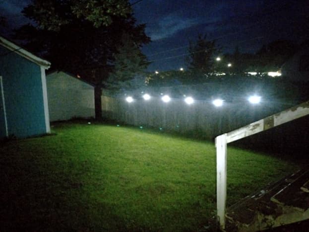 Solar lights are set to produce white light, providing a path along the fence