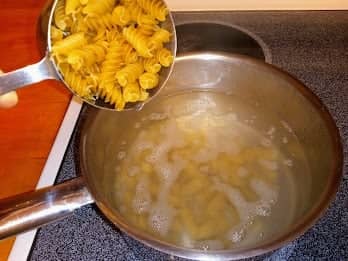 Add 2 cups of fusilli pasta to boiling water. Cook over medium heat for 7-10 minutes.