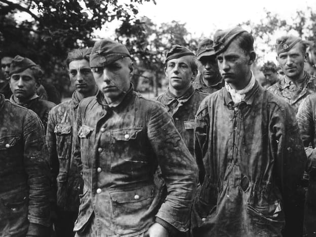SS Hitlerjugend troops taken prisoner in Normandy 1944. They were bombarded with Nazis political indoctrination growing up under Adolf Hitler's rule. 