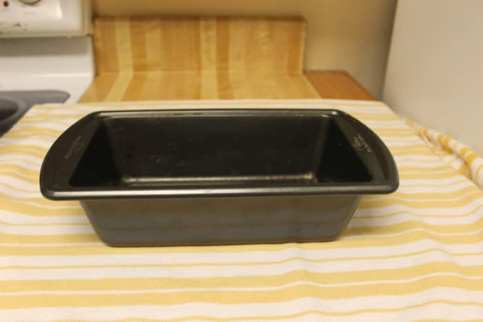 Grease a loaf pan with unsalted butter and set aside.