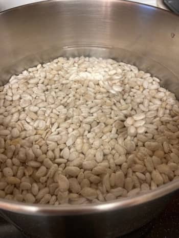 Soak the beans overnight in a pot of cold water.